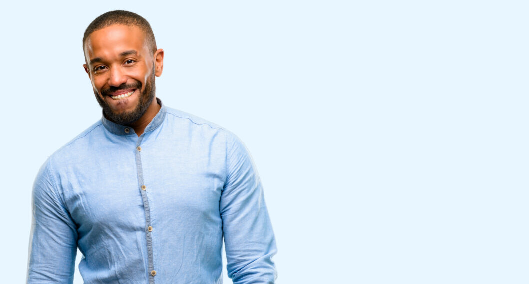 African american man with beard confident and happy with a big natural smile looking side isolated over blue background
