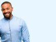 African american man with beard confident and happy with a big natural smile looking side isolated over blue background