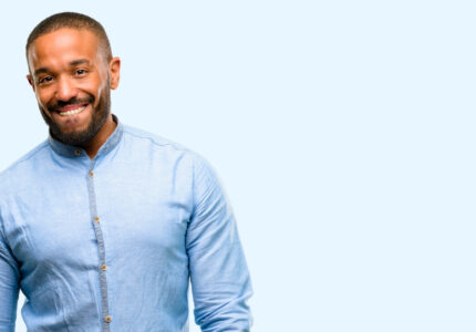 African american man with beard confident and happy with a big natural smile looking side isolated over blue background