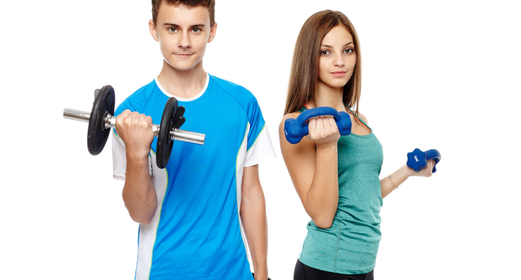 Two teenagers boy and girl doing fitness workout with weights isolated on white background