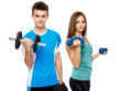 Two teenagers boy and girl doing fitness workout with weights isolated on white background