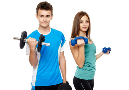 Two teenagers boy and girl doing fitness workout with weights isolated on white background