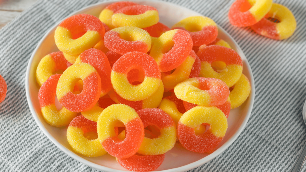 peach rings in a ceramic dish on a striped towel