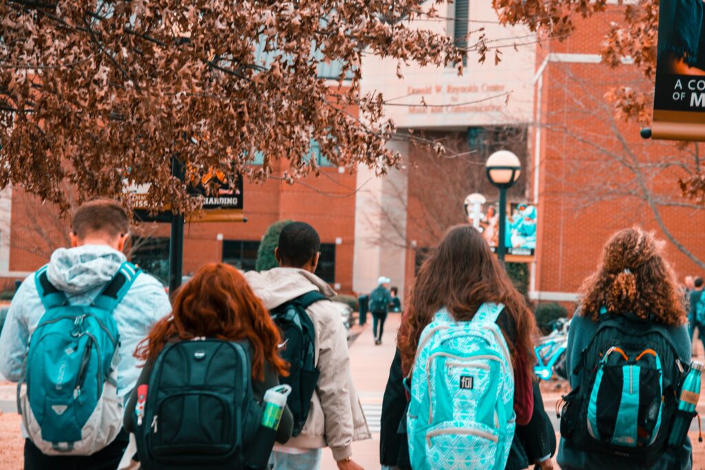 Going to college out-of-state: students with their backpacks walking into the building.