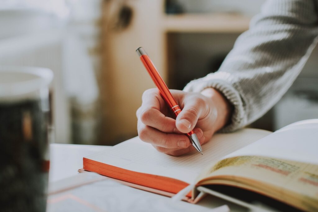 Person writing in notebook