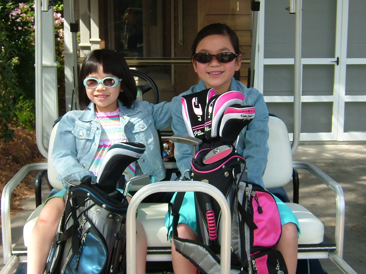 Sisters adopted from China in a golf cart