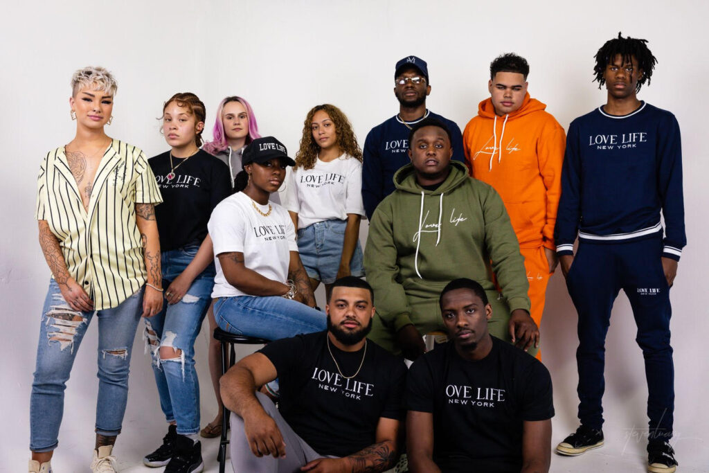 happy people wearing clothing saying Love Life.