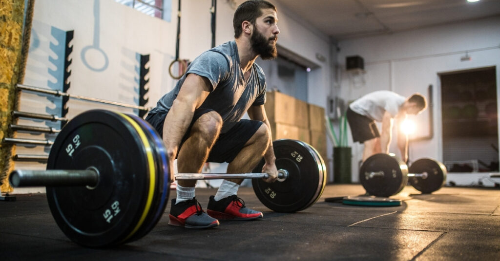 a man doing deadlifts at a gym