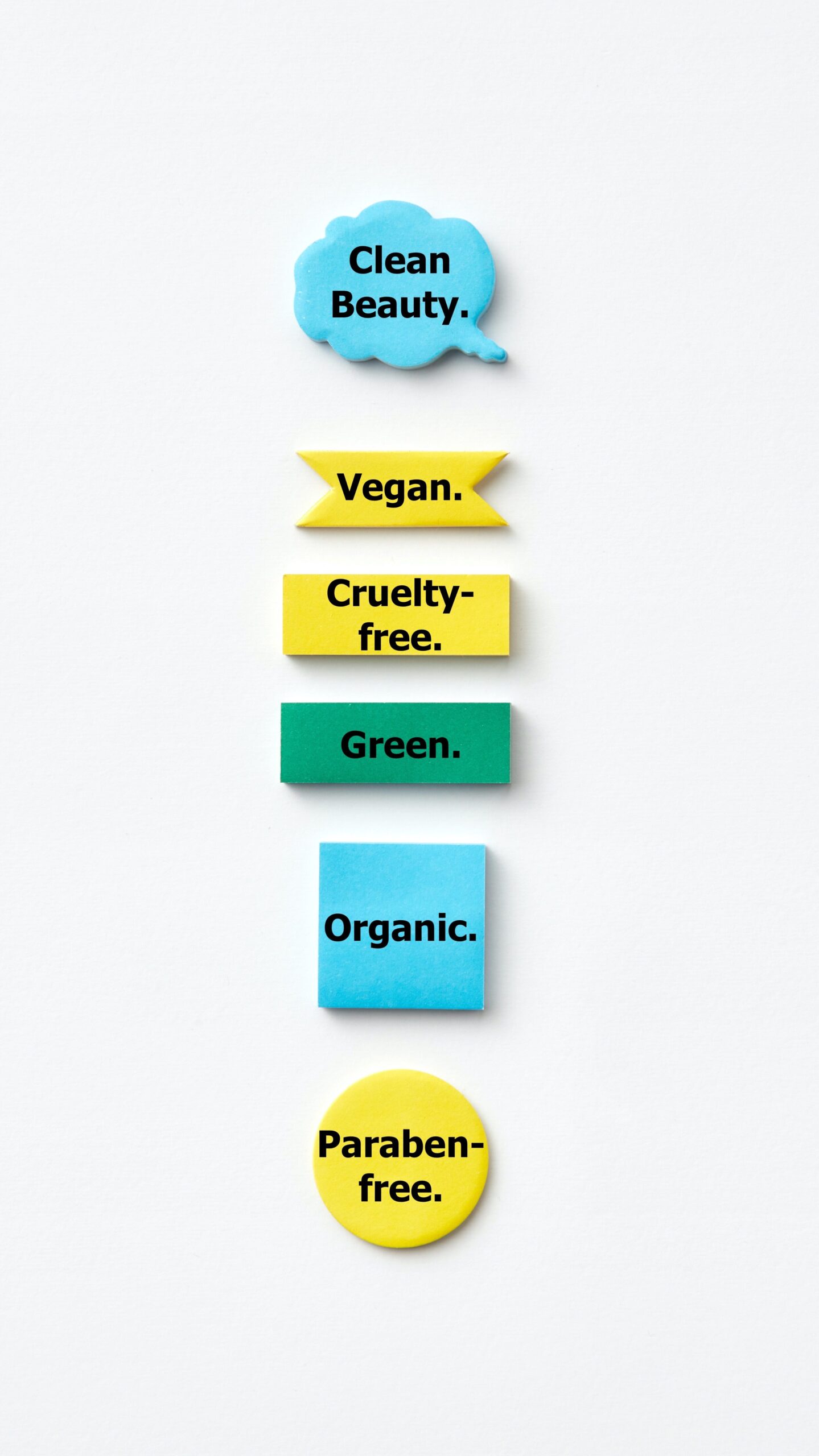 sustainable business buzzwords on sticky notes in various shapes and colors (blue shoutout bubble, yellow ribbon, yellow rectangle, green rectangle, blue square, yellow circle) arranged vertically