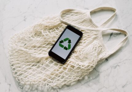 https://www.pexels.com/photo/mobile-phone-with-green-recycling-sign-and-mesh-bag-3850512/