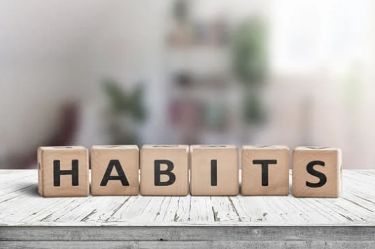 The word habit spelled out on wooden blocks for the How to Develop Leadership Skills in Employees post