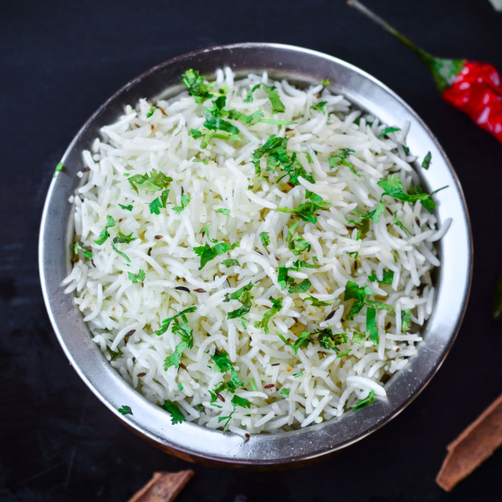 bowl of fluffy white rice mixed with cilantro greens