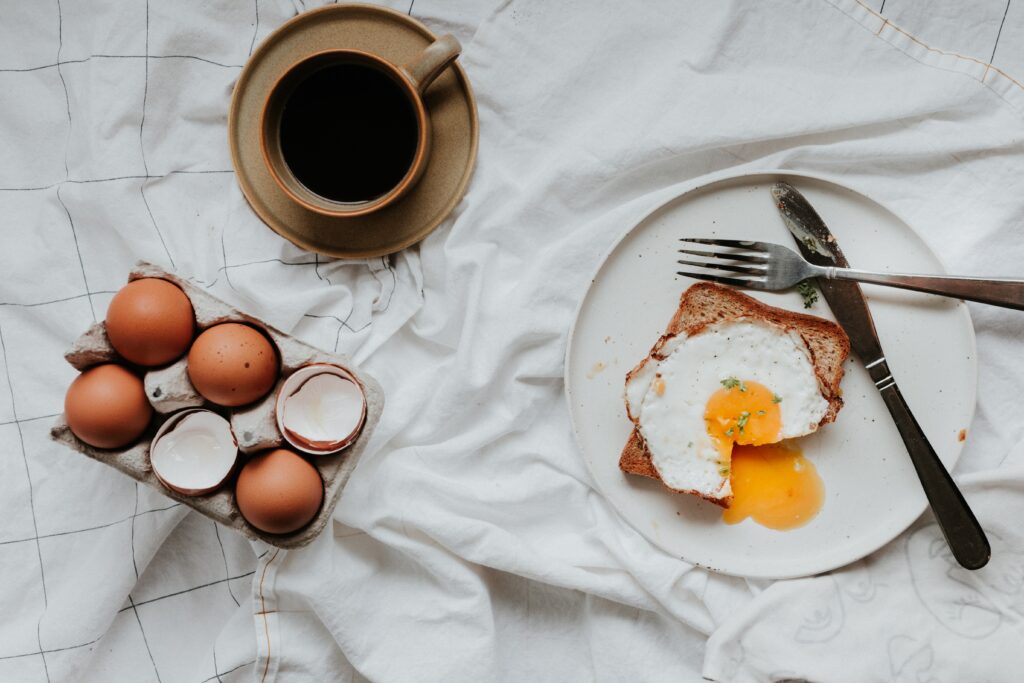 Healthy eating made simple by putting down your utensil. Eggs and coffee with fork and knife.