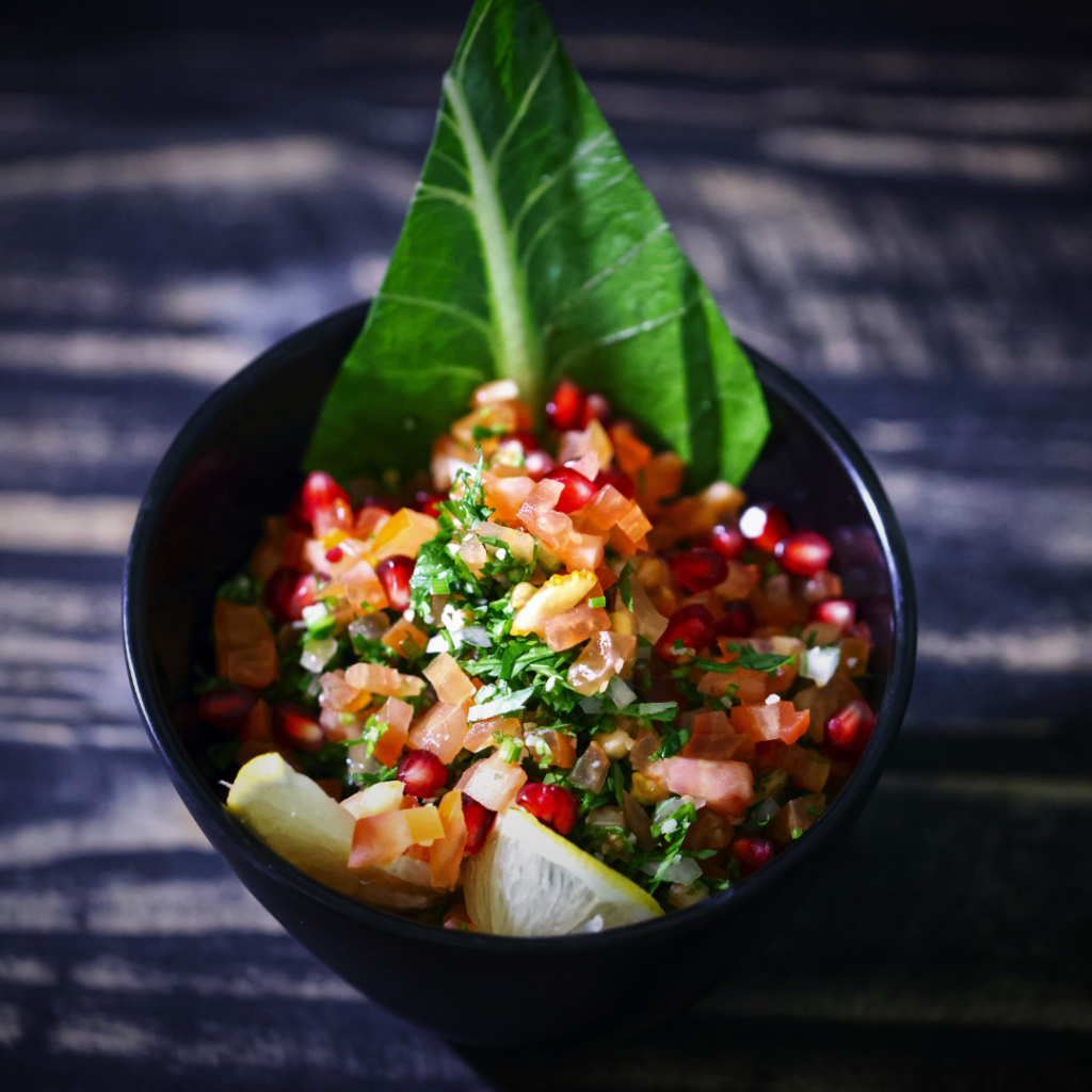fresh fruit salsa with cilantro on black background