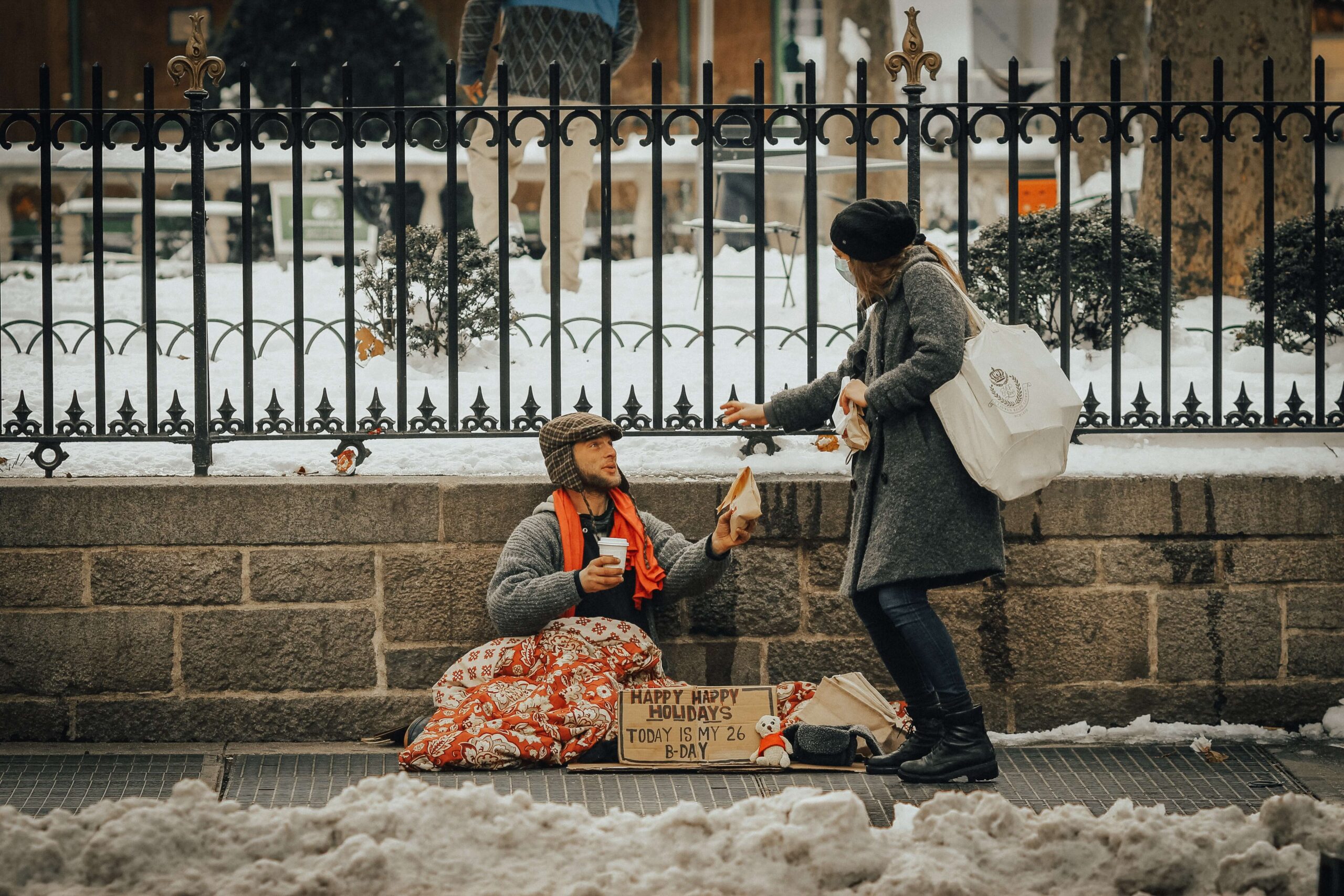 person giving homeless winter care kit