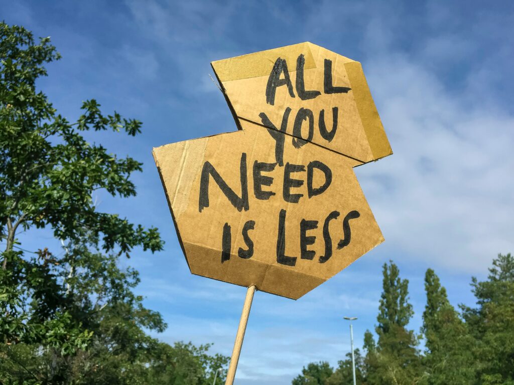 all you need is less cardboard sign