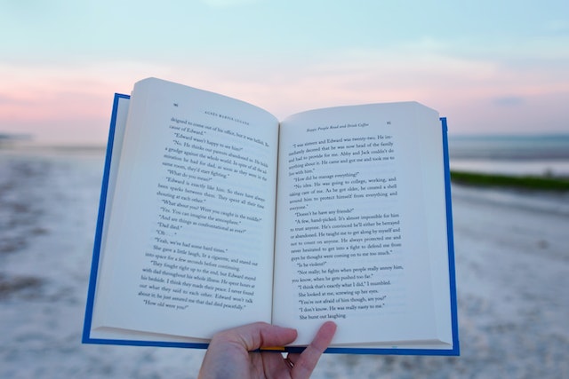 open fiction book on beach