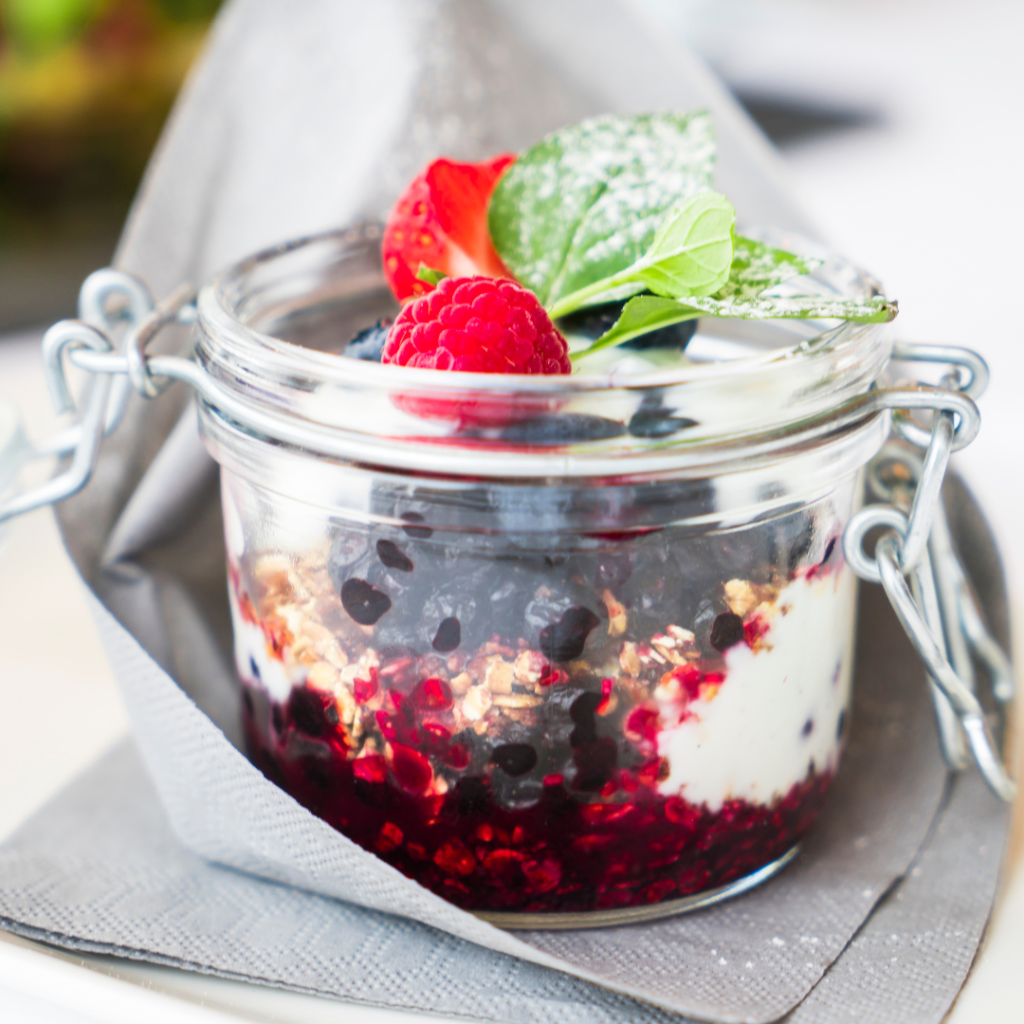 overnight oats in a mason jar with raspberries and other fresh fruits perfect for vegetarians