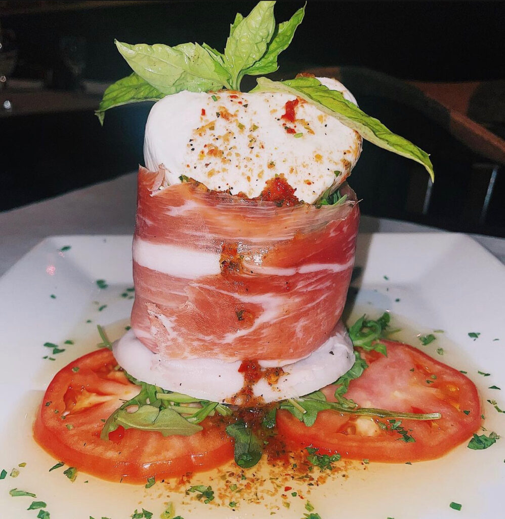 Burrata on tomato with prosciutto from Woodstone Bar and Grill - good restaurants in Paramus, NJ