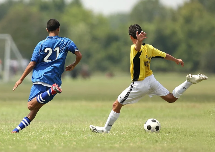 two friends playing soccer two friends playing soccer