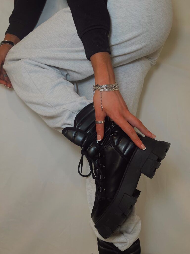 black Platform Fashion Boots paired with grey jogger sweatpants and silver jewelry