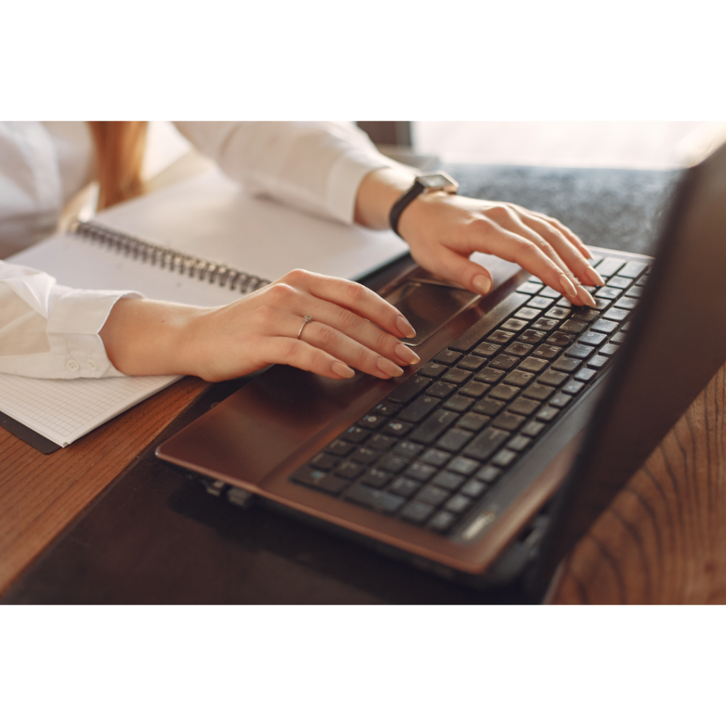 hands typing on computer