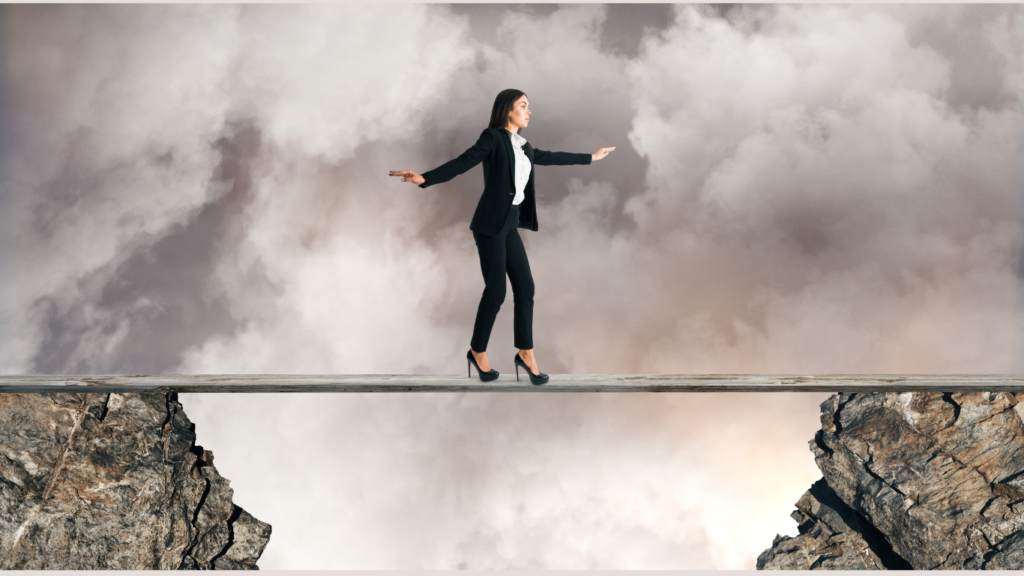 Woman balancing on a plank between two rocks