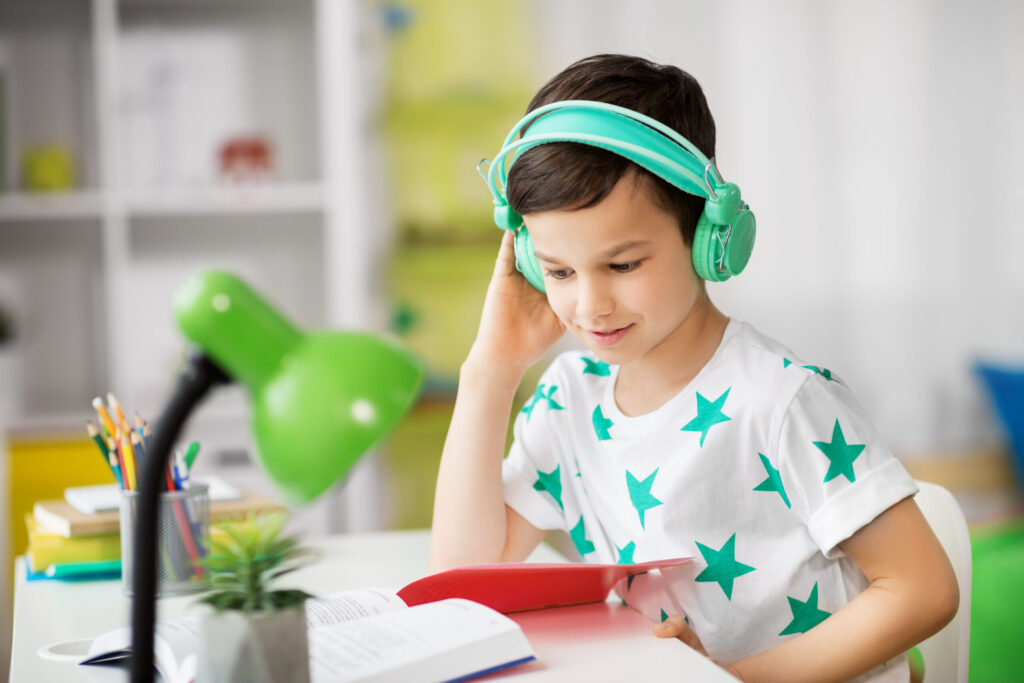 young boy listening to preschool audiobooks