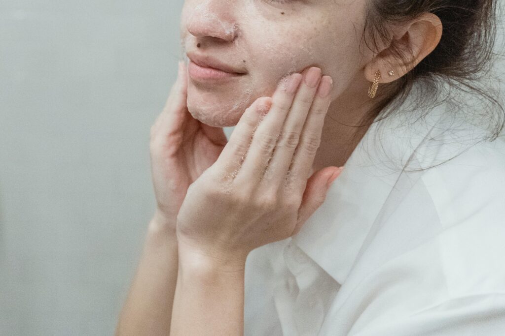 woman washing face with non-toxic skincare