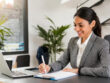 woman in background in a business professional office, writing about logo on table
