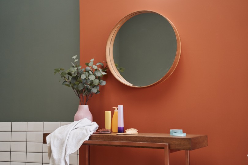 Vanity and mirror with toiletries and towel