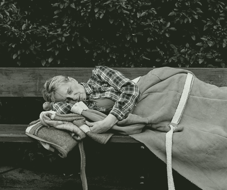 homeless lady sleeping on bench