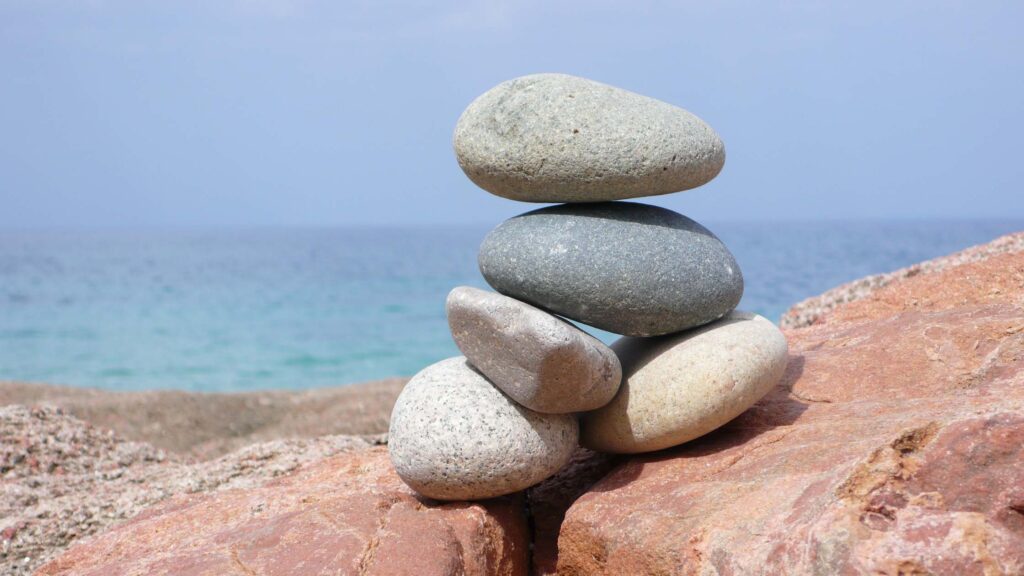 Cairn on a beach, patience in getting therapy
