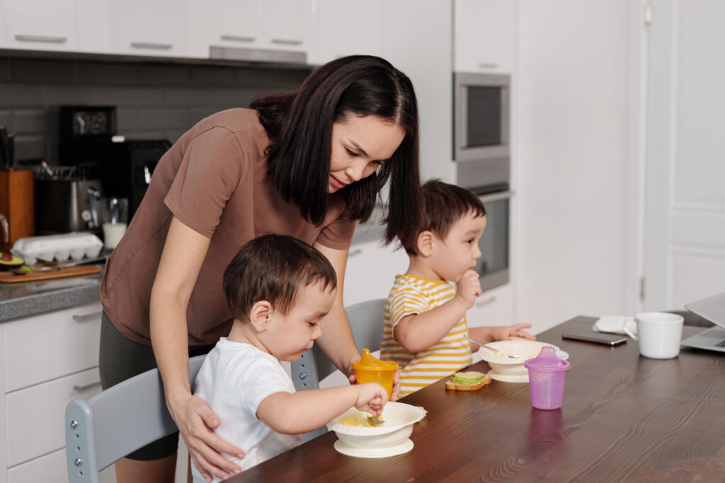 Woman feeding kids