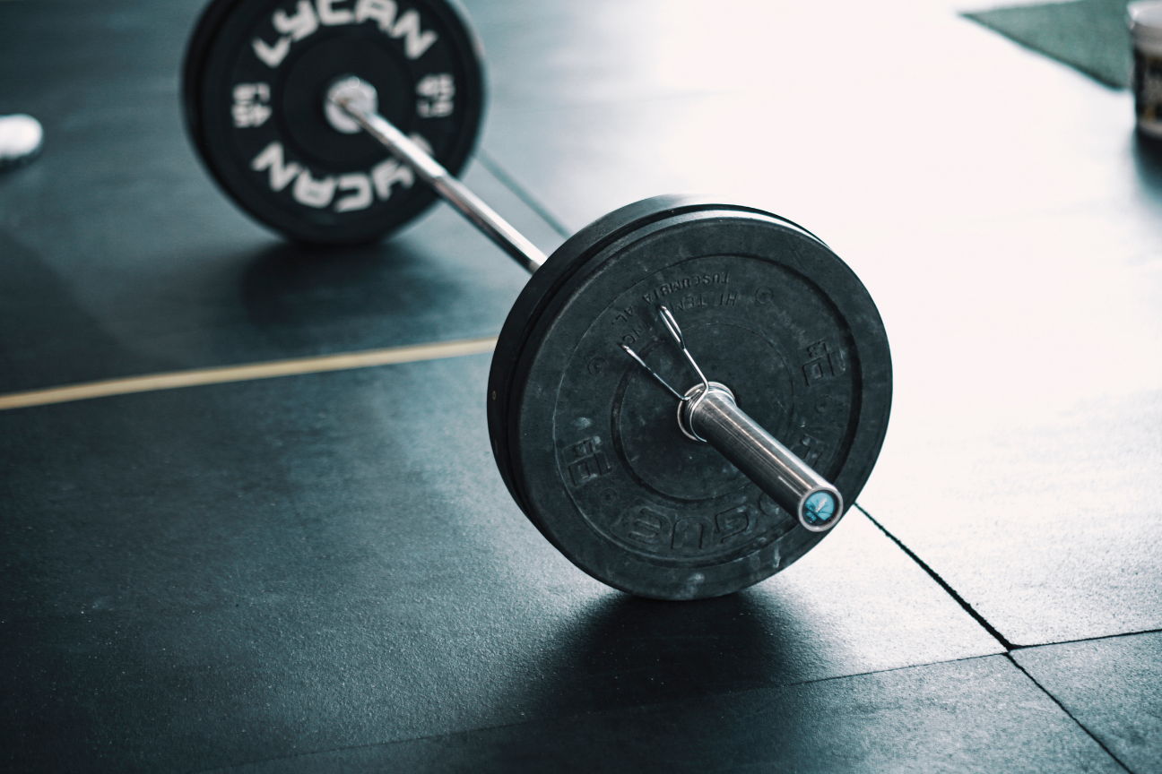 Barbell with weight plates on the floor for a workout routine