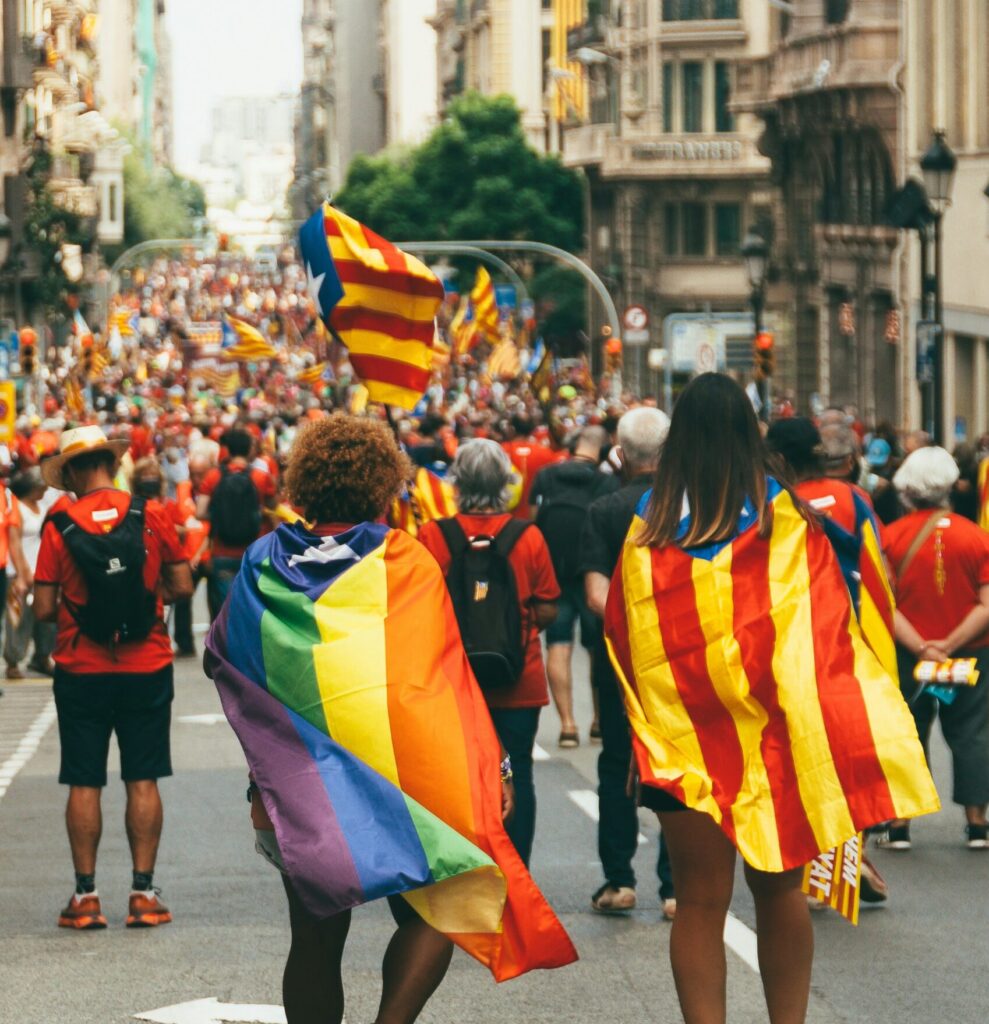 A vibrant Pride festival in Spain celebrating LGBTQ+ diversity, highlighting the intersection of Latinx identity in cultural events.