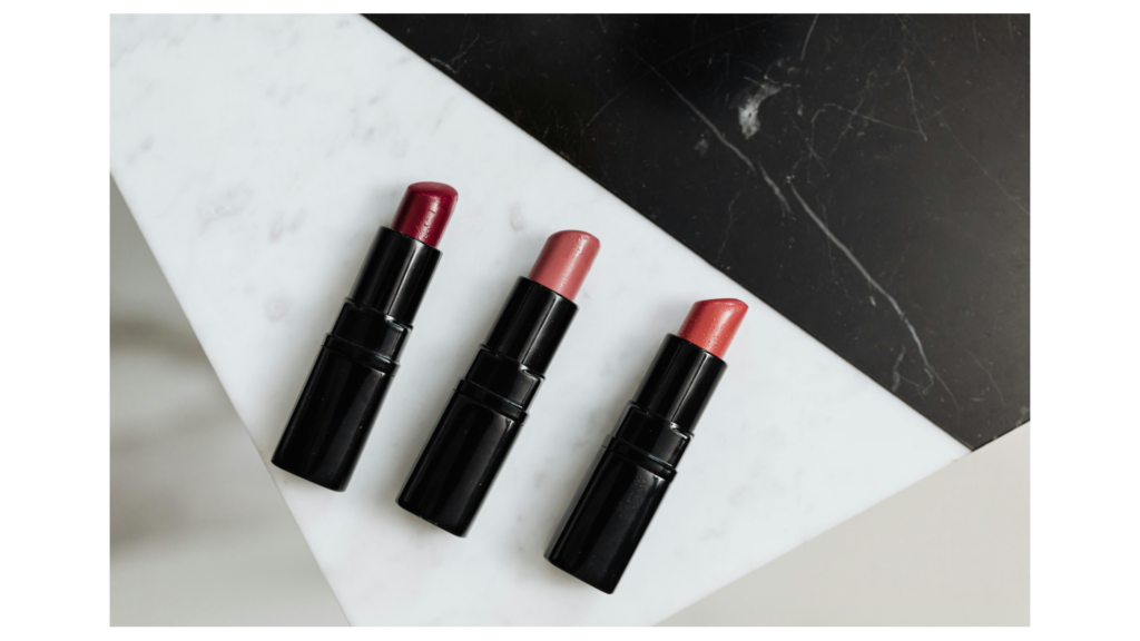 three different lipstick shades on marble counter.